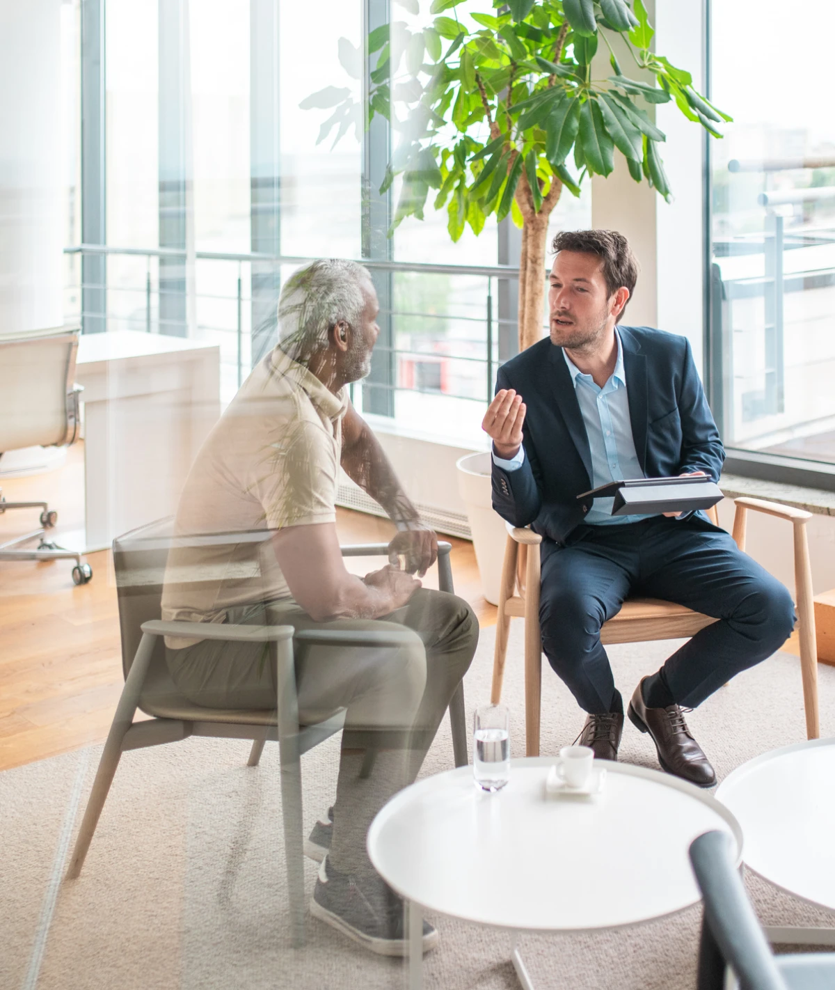 Two men discussing work indoors