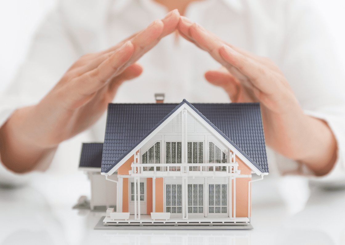 House model under protective gesture
