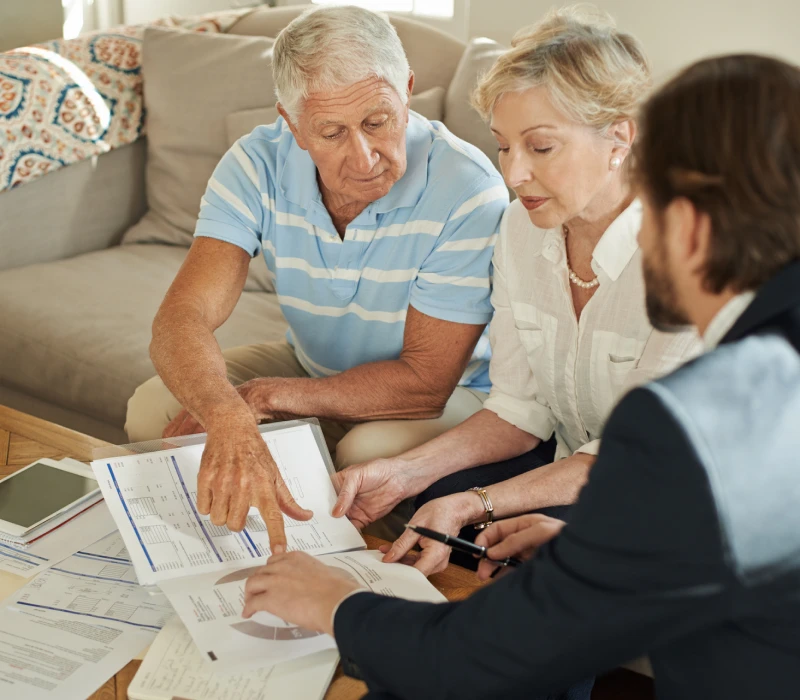 Elderly couple reviewing financial documents
