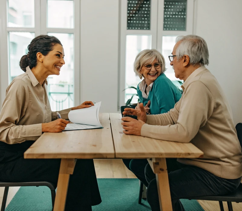 Smiling woman meeting with older couple